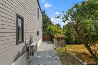 Additional yard. Level & hard panned gravel, this is a great space to add a shed.