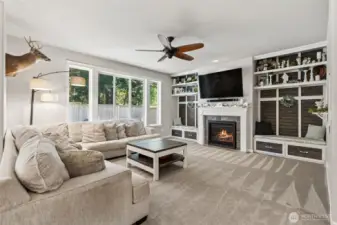 Custom built bookshelves surrounding fireplace