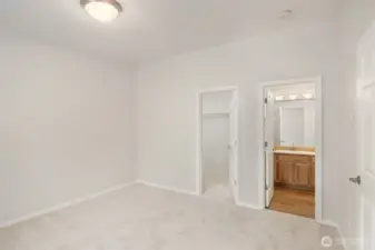 Primary bedroom with walk in closet and ensuite bathroom.