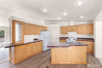Convenient kitchen island and plenty of cabinets over tile countertops