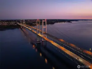 The magnificent Narrows Bridge is fully lit at night.