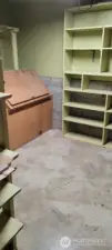 Basement storage with large built in bins and shelving.