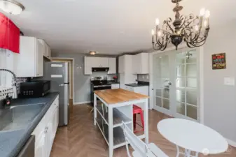 Butcher block island will convey, and can easily be shifted around to meet your needs.