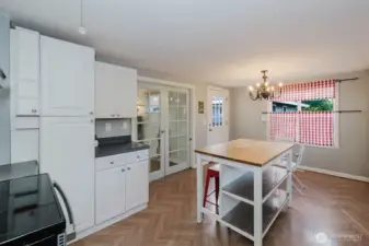 Extra cabinets and potential coffee nook right off the French door entryway.