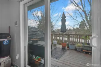 Patio door to rear deck overlooking backyard.
