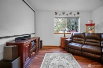 Another view of the family room. Projector and screen will remain for the new owner. Imagine fun movie nights here!