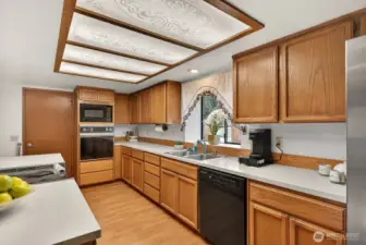 Kitchen has a nice flow and kitchen window looks out the front of the house. Door to garage.