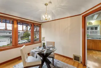Dining room bathed in light from windows taking in the view.