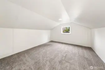 A comfortable upper-level bonus room offering adaptable space for play, study, hobbies, or work-from-home needs.