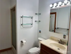 3/4 bath from hallway entrance. Door in mirror is to the second bedroom.