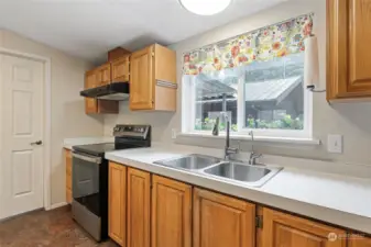 The door to the left of this light and bright kitchen leads to the utility/mud room. A covered short walkway leads to the oversized garage with ample workshop space. Every window in this amazing home offers a fabulous view of natural beauty and showcases the privacy and quiet you'll enjoy here.