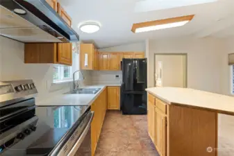 The gleaming kitchen provides ample counter-space and storage.