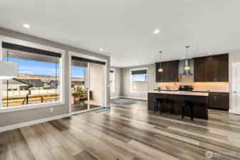 Open-concept living, kitchen, and dining area with easy access to the patio.