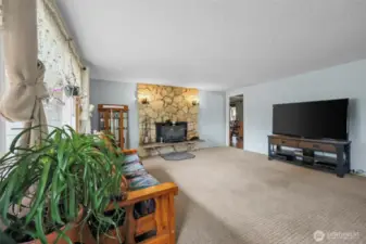 Main entrance opens up to the primary living space with stone fireplace.