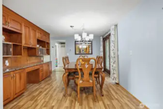 Dining space with custom built ins, offering plenty of storage. Dining table stays with home.