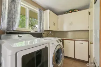 Utility space is off of dining room and secondary living area. W/D stay with home.