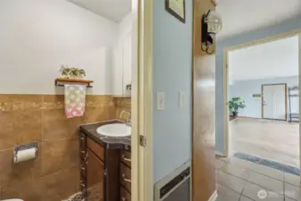 1/2 bath is located off of utility space. Dining space is to the left.