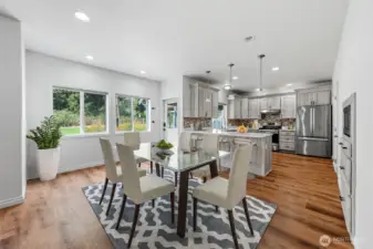 Virtually staged dining in between kitchen and family room