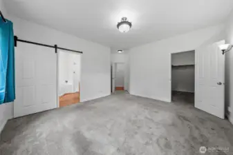 Primary bedroom, closet on right with bathroom on left