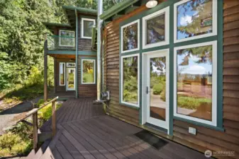 Living room access to deck & primary bedroom access to deck in the distance