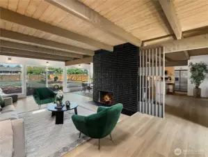 The bold dual sided fireplace is a captivating focal point for the main living spaces of the house