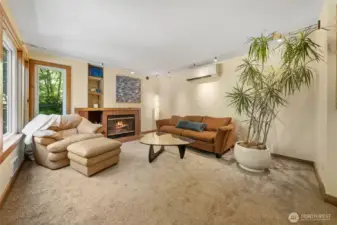 Inviting living room has a wood burning fireplace~
