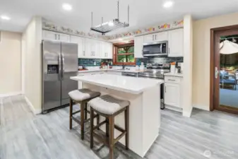 A stylish overhead pot rack adds both function and charm to the kitchen. The new 2024 stainless steel refrigerator features an ice and water dispenser, complete with new water and air filters for freshness and convenience.
