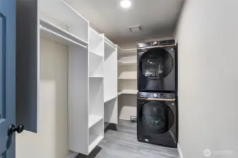 The utility room features a new stacked Samsung washer and dryer. All smart appliances connected to your Samsung app and TV for convenience. A new 50-gallon electric water heater (2024) with leak detection and auto shut-off adds peace of mind.