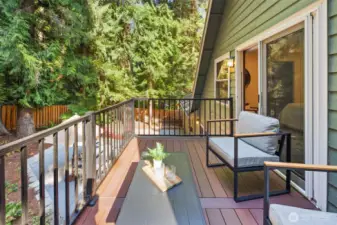 The primary suite’s balcony is impressively spacious, offering plenty of room for multiple seating arrangements. It’s an ideal spot to unwind, entertain, or simply enjoy the peaceful treetop surroundings.
