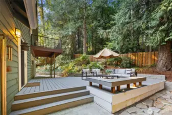 This private backyard is designed for both quiet retreat and easy entertaining. Enjoy a moment to yourself on the expansive composite deck with its built-in bench, or gather with friends around the stone patio and fire pit. The balcony off the primary suite offers yet another serene perch, surrounded by evergreens that make the space feel like your own forest hideaway.