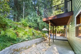 The decorative stone walkway is extensive, with beautiful natural greenery, making a lovely place for deer watching all year! The stone walk way matches the path in front of the house, leading to the gardens and side yard.