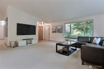 As you enter, you will love the open-concept layout that greets you. This huge great room with large windows features cathedral ceilings and beautiful carpet.