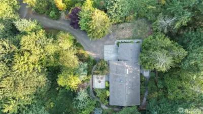 Drone overhead view showing the longer driveway and most of the over 1ac in land.
