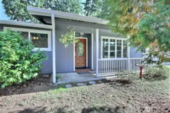Front door and covered porch offer a cozy spot to relax and enjoy your morning coffee or greet neighbors!