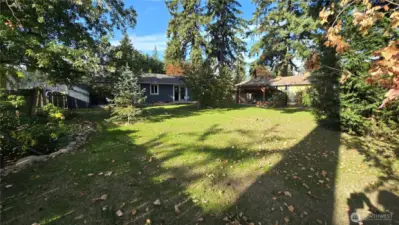 Enjoy a picture-perfect backyard featuring lush new grass and mature landscaping.