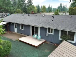 Patio features a covered area and there is a garden shed.