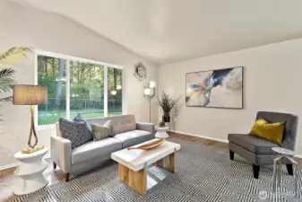 With vaulted ceilings and generous windows, the living room feels open, bright, and filled with natural warmth.