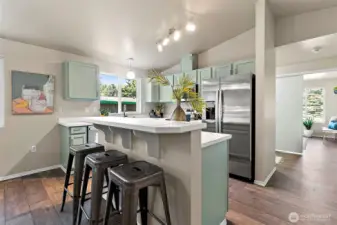 At the heart of the open kitchen, the island with its welcoming breakfast bar invites everyone to gather, whether for a quick bite, conversation, or a cozy start to the day.