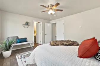 Step into the spacious primary bedroom, where beautiful French doors, fresh new lighting, and a ceiling fan create a bright, relaxing haven filled with character and comfort.