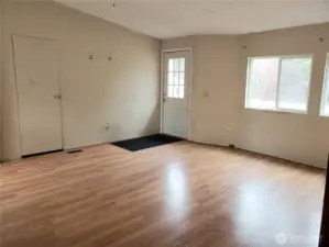 Picture of the Huge Living Room Showing Laminate Flooring Looking at the Front Entry Door.