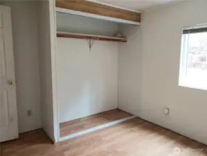 Another View of the Large Second Bedroom with Laminate Flooring Showing Closet.