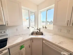 Double windows over sink let in lots of natural light and provide a water view
