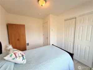 Another view of guest bedroom with included armoir and bed