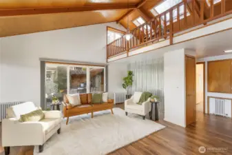 Living room with door to side patio and BBQ area