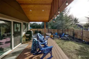 Gorgeous covered TREX deck overlooking professionally landscaped, fully fenced backyard