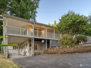 Follow driveway to lower level covered patio - or use as a carport