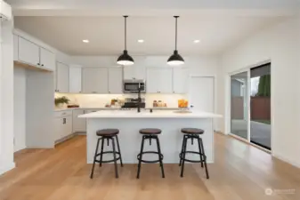 Kitchen w/quartz countertops & island - Pics are of a different 2389 Kyler plan home. Features and colors may differ.