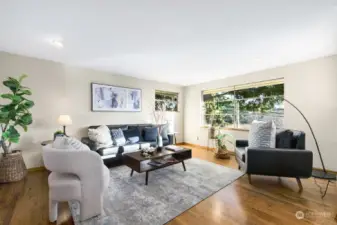 The living room features room for your entire living room suite an has a wall of eastern windows for warm morning sun and views to the east of homes below and the Seola Greenbelt. This home features gorgeous hardwood floors throughout.