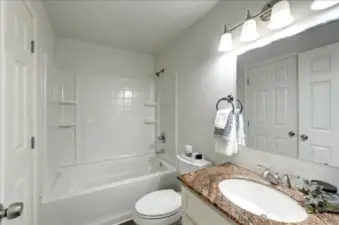 Full bath on the main floor. Notice the granite counter and newer vanity in here too.