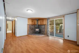 Cozy family room with wood stove and sliding doors leading to the back deck